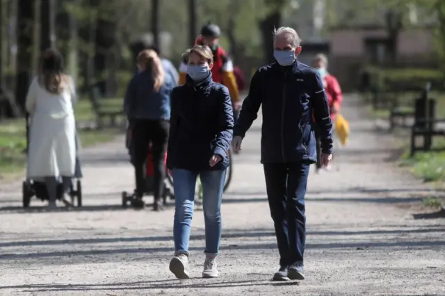 People walk through a park in Lodz