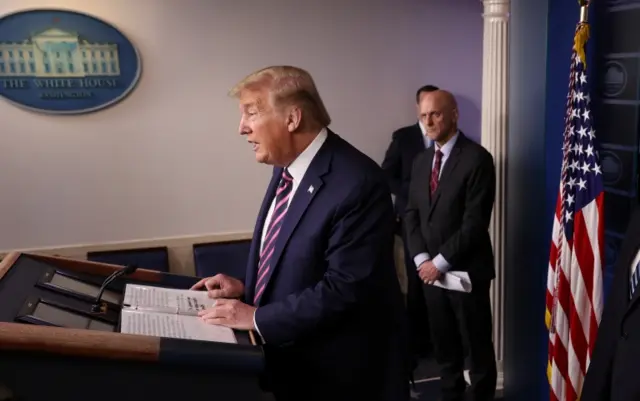 U.S. President Donald Trump leads the daily coronavirus task force briefing as Food and Drug Administration (FDA) Commissioner Dr Stephen Hahn listens at the White House in Washington, 24 April 2020