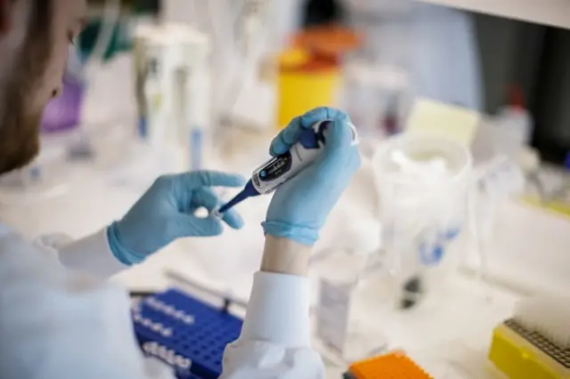 A researcher works on a vaccine against the new coronavirus