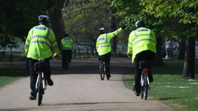 Police in London enforce restrictions in a park