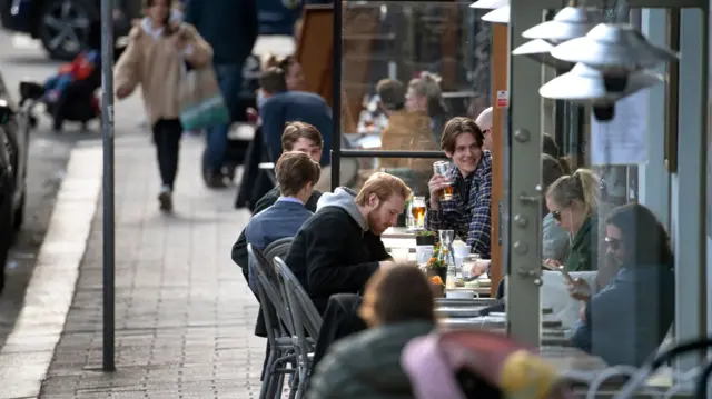 People enjoy themselves at an outdoor restaurant in Stockholm