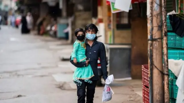 A man carries shopping in India