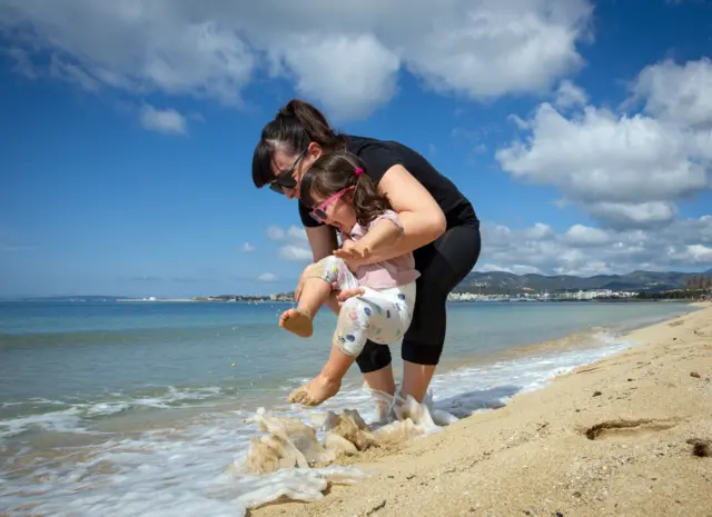 Child plays at beach