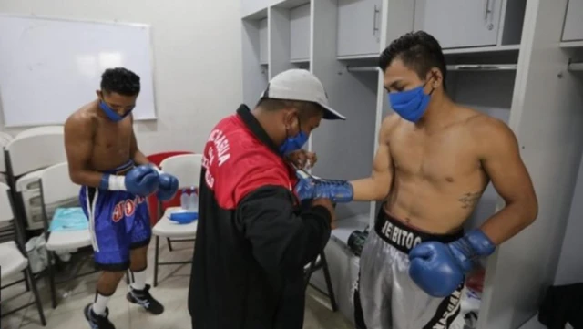 Boxers in Nicaragua wear face masks as they prepare for their bout