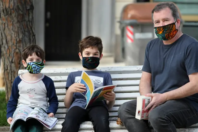 Family read books outdoors