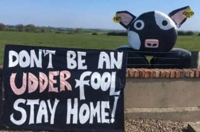 A sign saying: Don't be an udder fool - stay home.