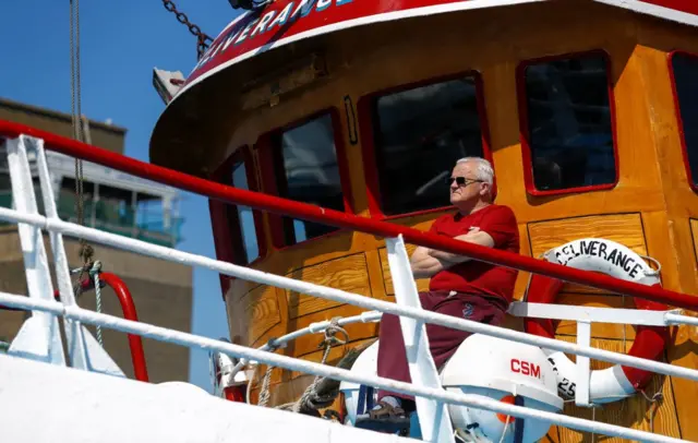 Man sunning himself on board a boat in Portavogie Harbour