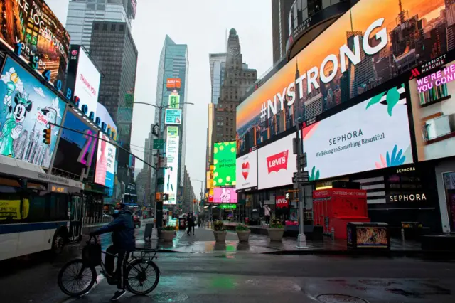 A man rides a bike in Times Square