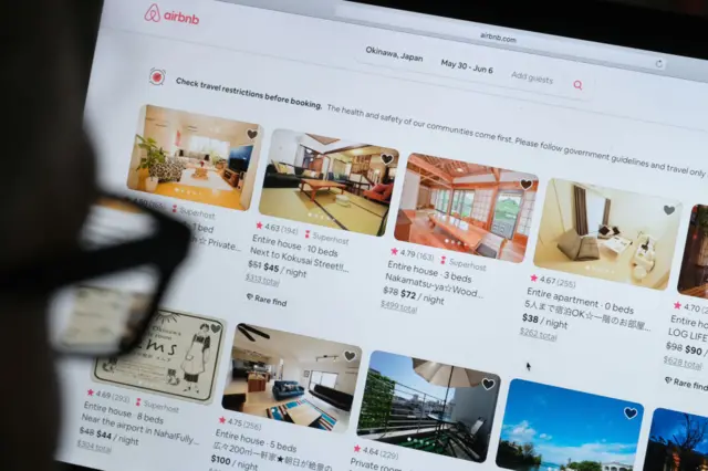 a man looks at the website of Airbnb