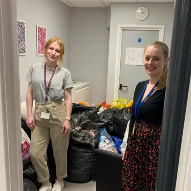 Officers with clothes for donation