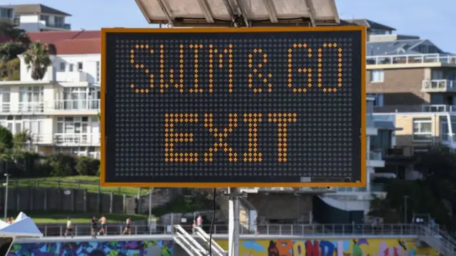 Sign at Bondi Beach reads Swim and Go Exit