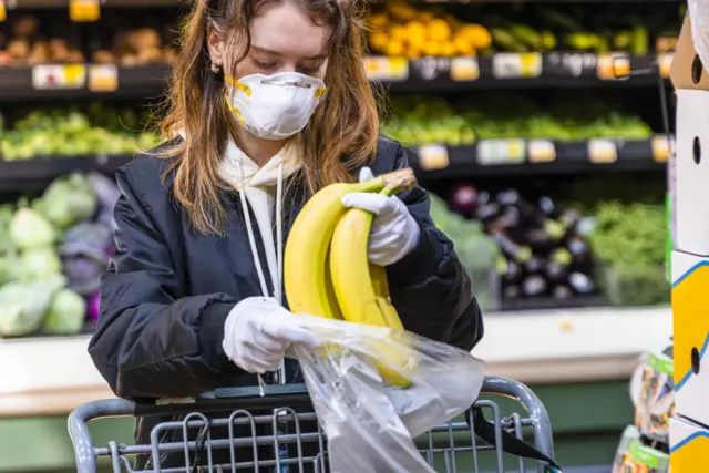 Woman wearing mask in supermarket