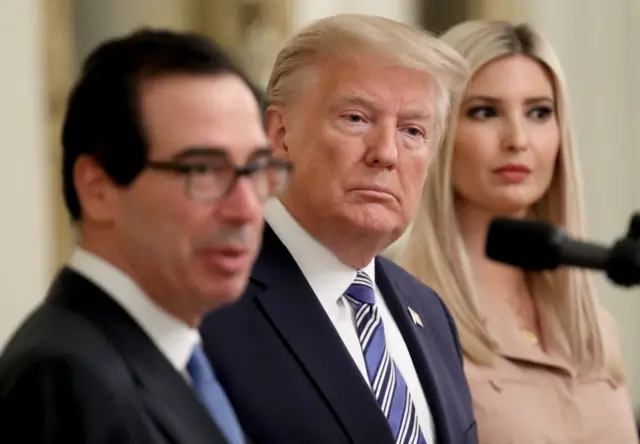 U.S. President Donald Trump and his daughter Ivanka listen as U.S .Treasury Secretary Steven Mnuchin speaks