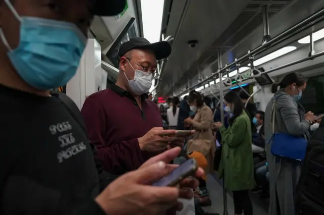 Commuters on a train in Beijing's underground wear masks. Photo: 28 April 2020