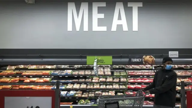 Shopper in the meat section of a supermarket in Washington, DC