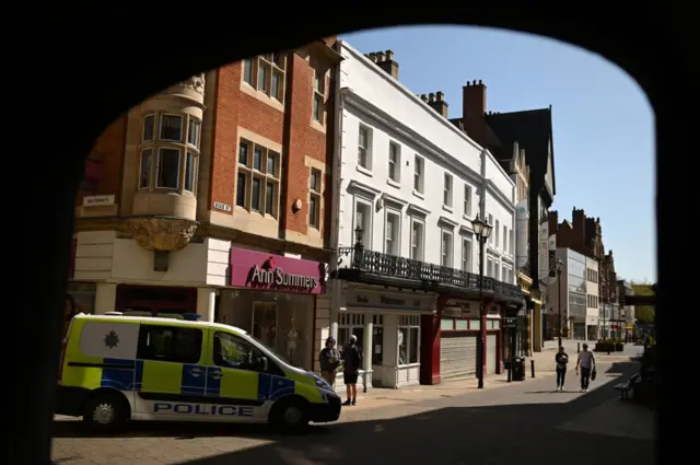 Police patrol the near-deserted streets of Lincoln
