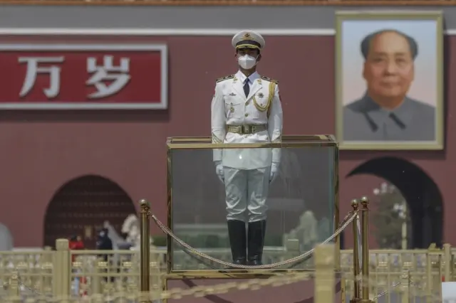 A Chinese paramilitary police officer wearing a face mask stands guard in front of a portrait of former leader Mao Zedong at Tiananmen Square in Beijing. Photo: 28 April 2020