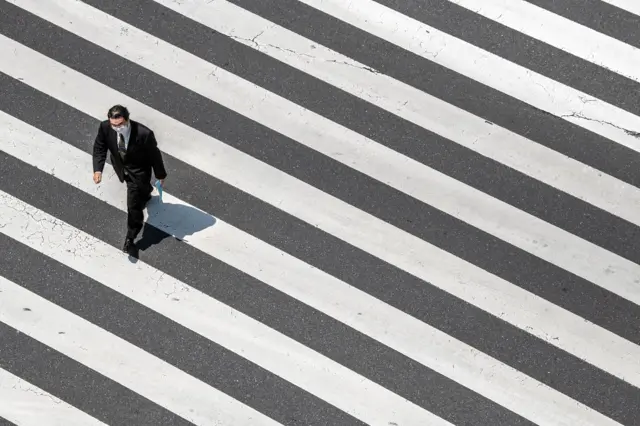 A man walks over a pedestrian crossing in Ginza