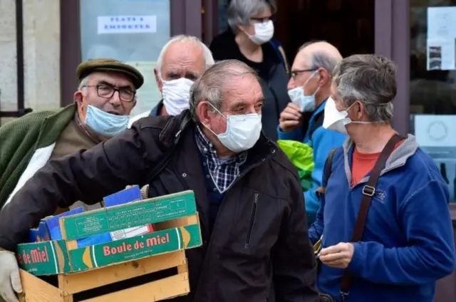 People in France shopping while wearing face masks