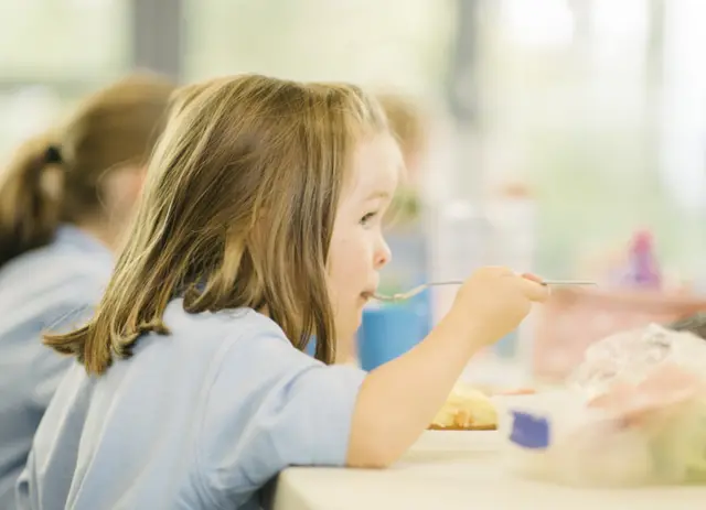 Girl eating school dinner