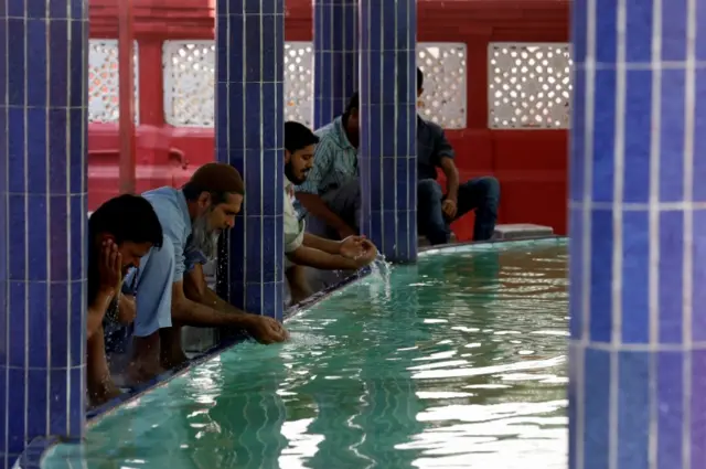 Muslims perform ablution as they gather to attend Friday prayer amid an outbreak of the coronavirus disease (COVID-19), at a mosque in Karachi, Pakistan March 20, 2020.