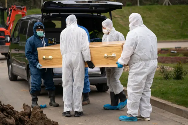 Ismail Mohamed Abdulwahab's coffin is carried at the Eternal Gardens in Chislehurst