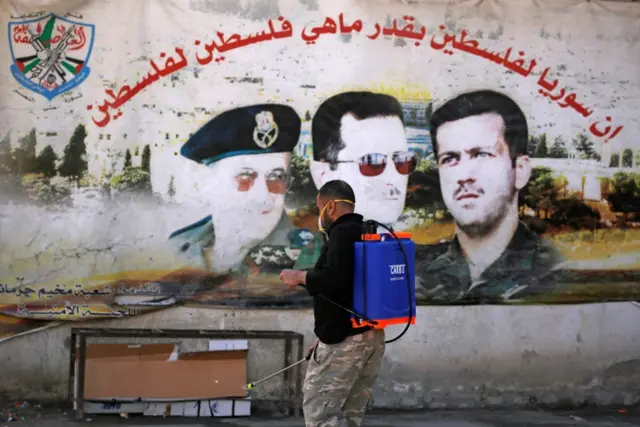 A man sprays disinfectant inside Jaramana Palestinian refugee camp in Damascus, Syria (1 April 2020)