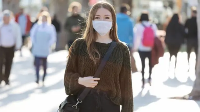 A woman wearing a mask in New York