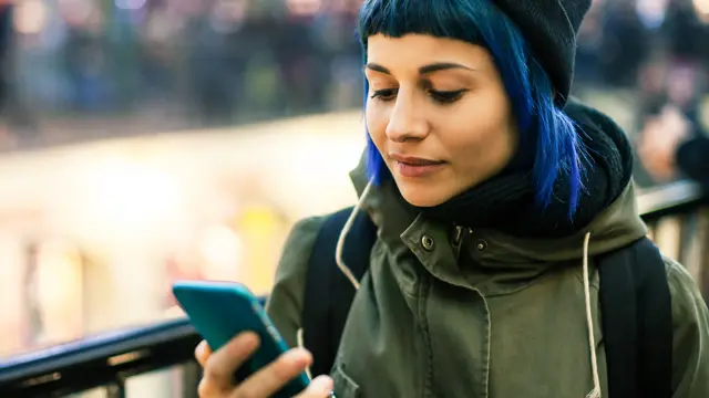 Young woman holding a mobile phone