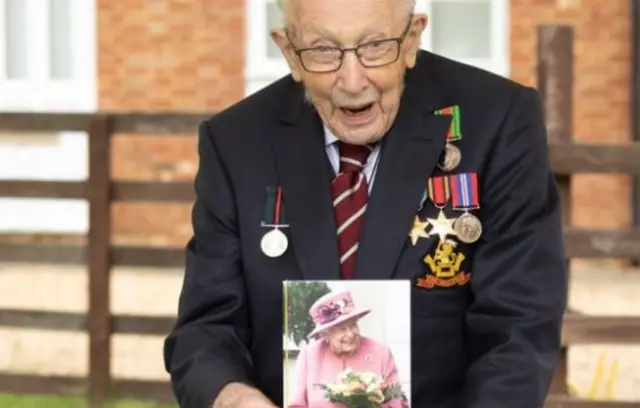 Captain Tom with 100th birthday card from the Queen