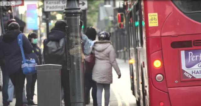 Workers in Harlesden getting on a bus to go to work