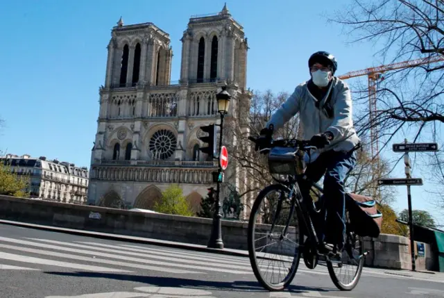 A cyclist near Notre Dame Cathedral, 30 Mar 20