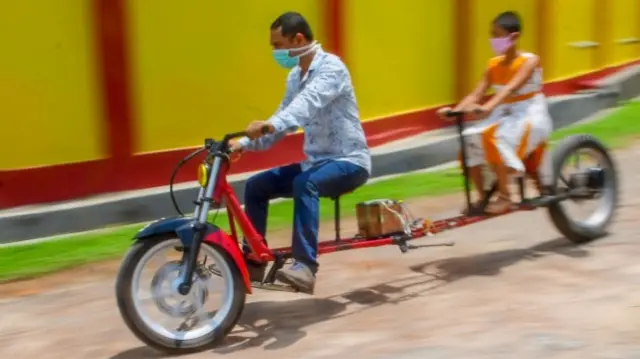 Mand and girl on a stretched motorbike