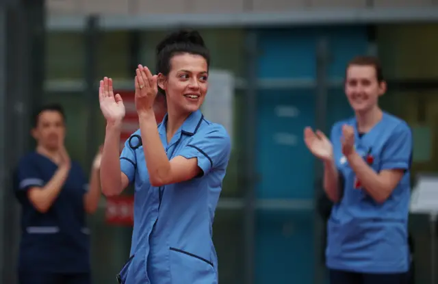 NHS workers react outside Birmingham Queen Elizabeth Hospital during the Clap for Carers