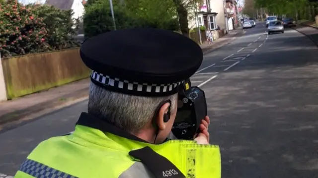 Police officer with speed gun