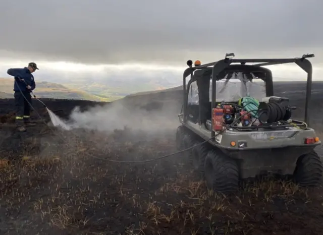 Firefighters working to extinguish the moorland fire