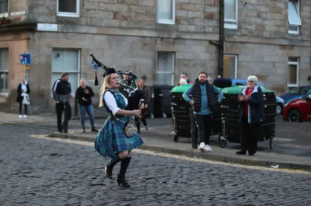 Piper Louise Marshall performs in Leith, Edinburgh, during Thursday's nationwide Clap for Carers to recognise and support NHS workers and carers fighting the coronavirus pandemic