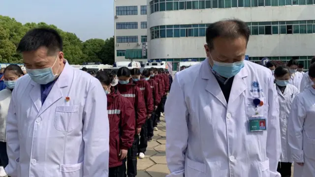 Doctors and other healthcare workers pay tribute at Wuhan Union Hospital