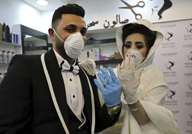 Palestinian couple Ammar and Baraa show off their rings before getting married near Hebron, West Bank