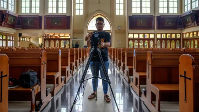 Man with camera in church