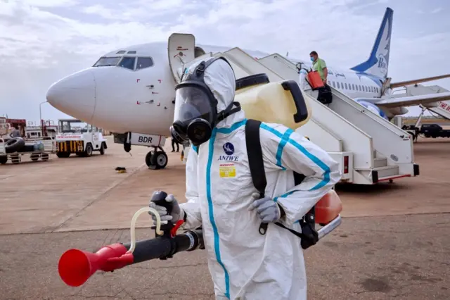 Airport staff disinfect a plane at Juba International Airport, South Sudan, 3 April 2020.