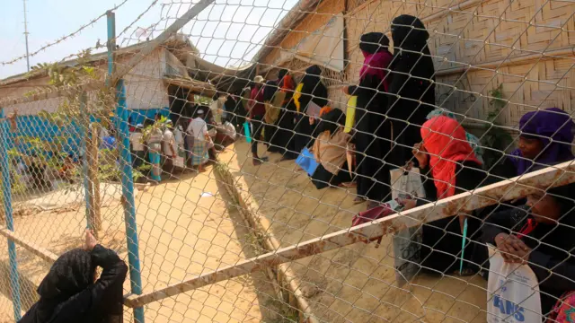 Rohingya refugees near Cox's Bazar in Bangladesh, standing close together without masks, pictured at end of March