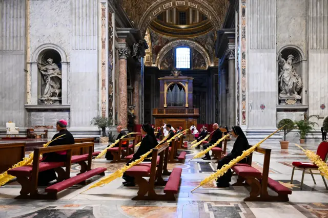 Service goers attend Palm Sunday service at St Peter's Basilica