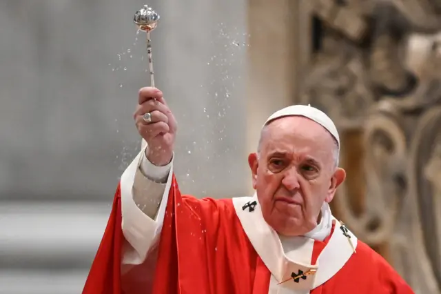 The Pope blesses attendees at a Palm Sunday service at St Peter's Basilica, Rome