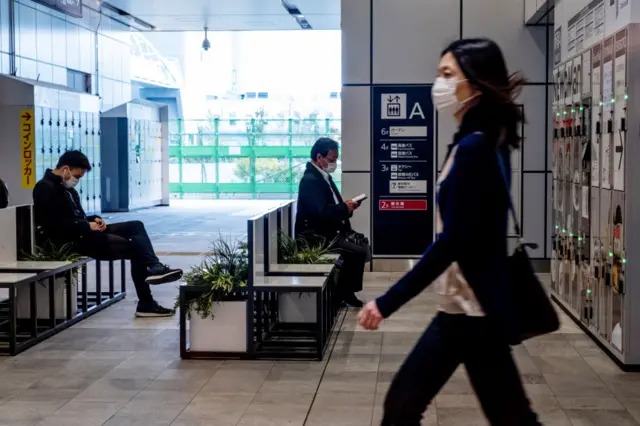 People in Tokyo's Shinjuku Station area wearing face masks