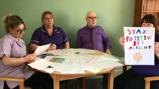 Care home staff with the letters they have received