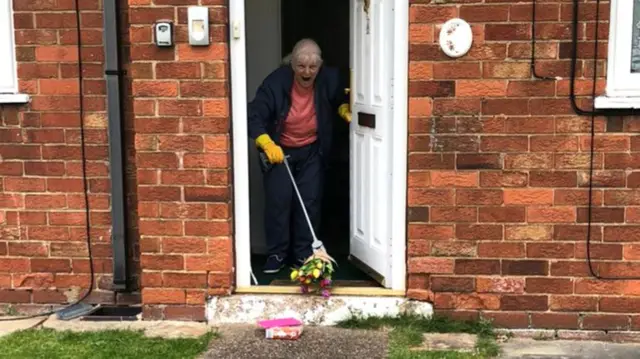 Mary picking up her flowers