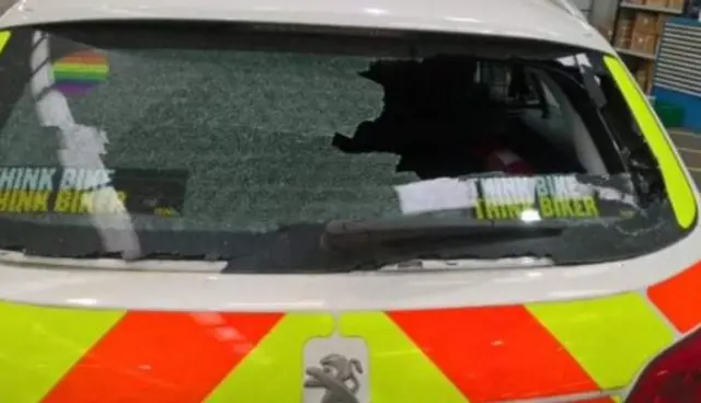 Police car with smashed rear window