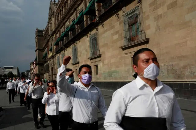 Waiters take part in a protest outside the National Palace to demand the federal government help with the loss of jobs