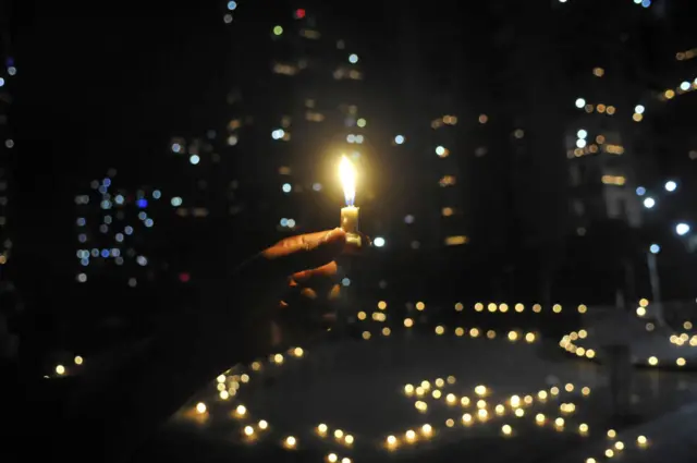 People's homes lit up with candles and earthen lamps